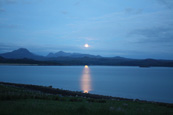 The moon rising over the Torridon mountain range with loch Gairloch in the foreground, Strath, Gairloch, Wester Ross, Scoltand