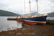 Boats at rest at low tide on Loch Fynne at Inverary Pier, Inverary, Argyll, Scotland